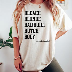 Bleach Blonde Bad Built Butch Body Funny T-Shirt, Funny Political Shirt, Crockett Clapback,Clap Back TShirt,Election T-Shirt, Black T- Shirt