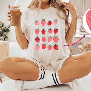 May include: A set of three ceramic mugs with a speckled, cream-colored glaze. Each mug features a different hand-painted floral design in shades of blue, green, and yellow. The mugs have a simple, rounded shape and a comfortable handle.