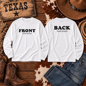 May include: Two white long-sleeve shirts displayed side by side. The left shirt features the black text FRONT YOUR DESIGN, and the right shirt features the black text BACK YOUR DESIGN. Both shirts have a crew neckline and long sleeves with ribbed cuffs.