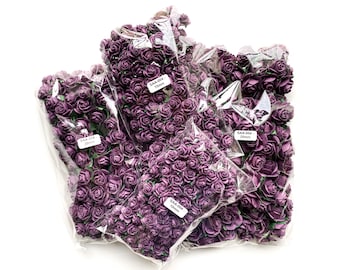 May include: Purple paper flowers in three sizes, 1.5 inches, 2 inches, and 2.5 inches, packaged in clear plastic bags. Each bag has a label with the size of the flowers.