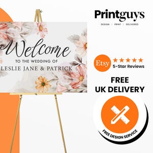 May include: A white welcome sign with a floral design featuring pink and orange flowers. The sign reads "Welcome to the wedding of Leslie Jane & Patrick".
