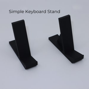 May include: Two black keyboard stands. Each stand has a flat base and a vertical support, with the text "Simple Keyboard Stand" above the stands.