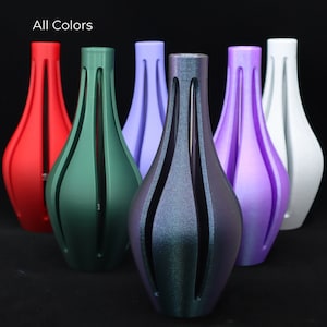 May include: Six decorative vases in different colors, including red, green, purple, blue, and white. The vases are all the same shape, with a wide base and a narrow neck. They are made of a smooth, glossy material.