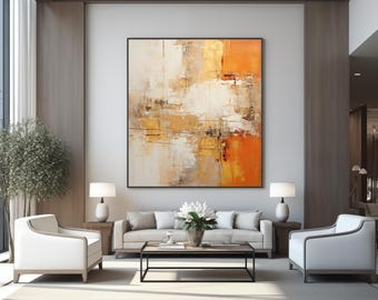 May include: Abstract painting with orange, gold, and white hues. The painting is framed and hanging on a wall in a modern living room with white furniture and a coffee table.