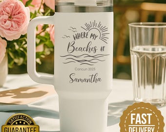 May include: White travel mug with a handle, a silver lid, and a straw. The mug features the text "Where My Beaches At" with a sun graphic, the location "Cancun 2025", and the name "Samantha".