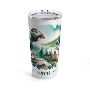 May include: A white stainless steel tumbler with a watercolor illustration of a puffin standing on a rock with a green and blue mountain background. The text "Let With You" is printed on the bottom of the tumbler.