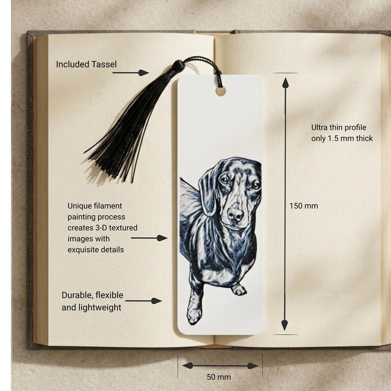 May include: A white rectangular bookmark featuring a black and white illustration of a dachshund. The bookmark includes a black tassel, measures 150 mm in length and 50 mm in width, and has an ultra thin profile of 1.5 mm thickness. The design is created with a filament painting process.