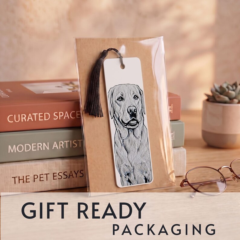 May include: A rectangular white bookmark featuring a detailed black and white line drawing of a Labrador Retriever dog. The bookmark has a dark brown tassel attached through a hole at the top and is enclosed in a clear plastic sleeve.