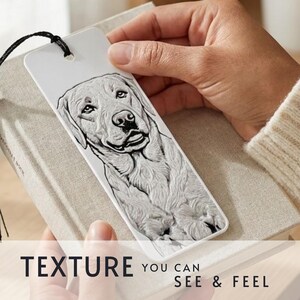 May include: A white rectangular bookmark featuring a detailed black and white embossed illustration of a Labrador Retriever dog. The bookmark has a black string attached at the top and displays the text "TEXTURE YOU CAN SEE & FEEL" at the bottom.
