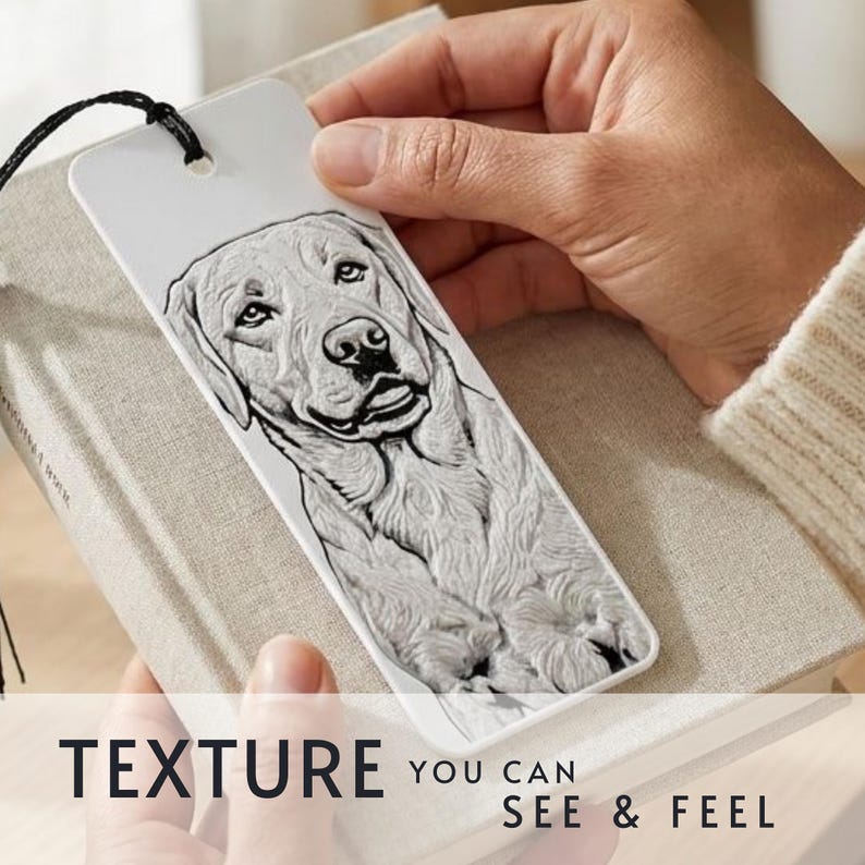 May include: A white rectangular bookmark featuring a detailed black and white embossed illustration of a Labrador Retriever dog. The bookmark has a black string attached at the top and displays the text "TEXTURE YOU CAN SEE & FEEL" at the bottom.