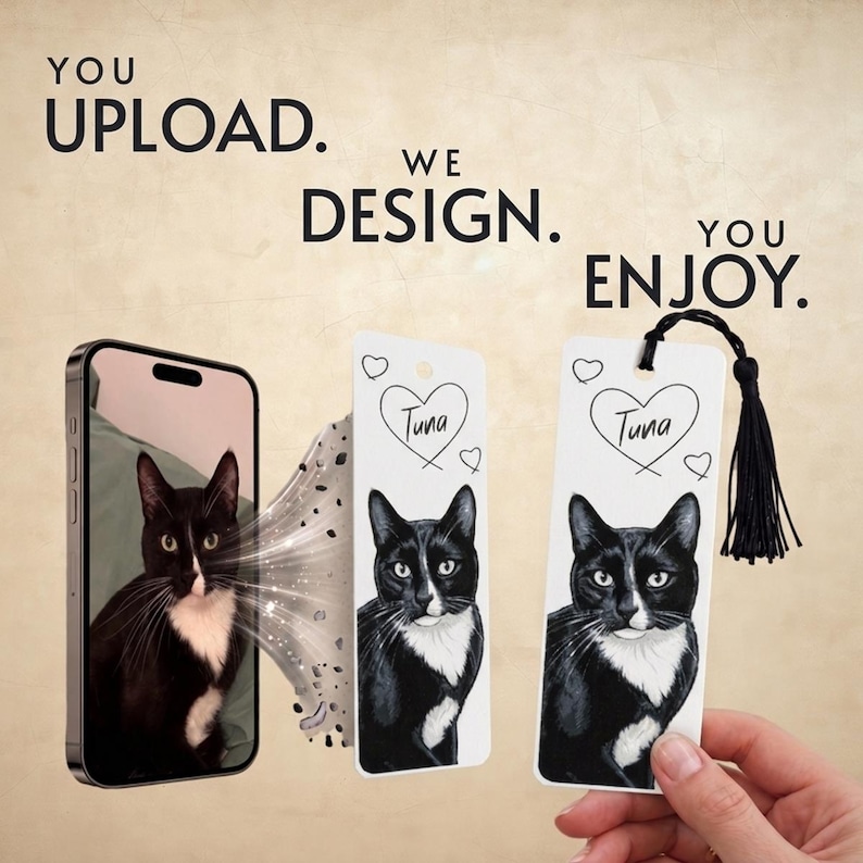May include: A smartphone displaying a black and white cat photo, next to a rectangular bookmark featuring a matching cat illustration with a heart and the name Tuna, and a finished bookmark with a black tassel. Text reads: YOU UPLOAD. WE DESIGN. YOU ENJOY.