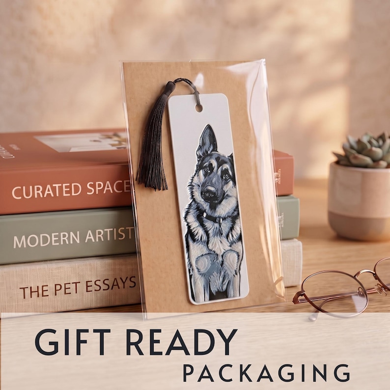 May include: A rectangular white bookmark featuring a detailed illustration of a German Shepherd dog. The bookmark has a hole at the top with a dark brown tassel attached and is enclosed in a clear plastic sleeve for protection and presentation.