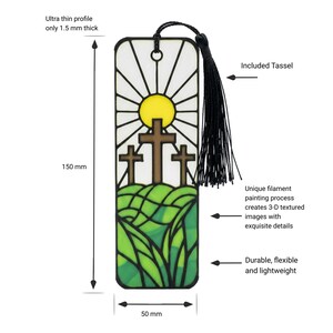 May include: A rectangular bookmark featuring a stained-glass style design of three brown crosses on a green hill under a yellow sun. It includes a black tassel, measures 150 mm by 50 mm, has a 1.5 mm thickness, and displays 3-D textured details.
