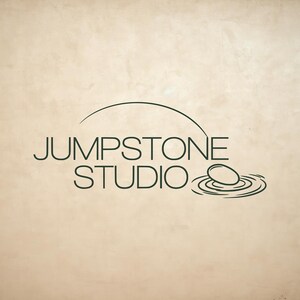 May include: A dark green logo on a light beige background featuring the text JUMPSTONE STUDIO in a clean sans-serif font. Above the text is a curved line, and to the right is a graphic of a stone hitting water, creating concentric ripples.