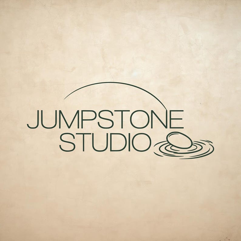 May include: A dark green logo on a light beige background featuring the text JUMPSTONE STUDIO in a clean sans-serif font. Above the text is a curved line, and to the right is a graphic of a stone hitting water, creating concentric ripples.