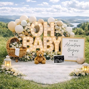May include: A scenic outdoor baby announcement setup with a large "OH BABY" sign, balloons, and a teddy bear. A sign reads "Our New Adventure Begins August 2026" next to a sonogram image. A wicker basket and lanterns complete the scene.