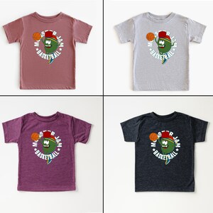 May include: Four children's t-shirts in mauve, grey, purple, and charcoal. Each has a cartoon character holding a basketball, with the words "STAR JAM BASKETBALL" in a circular design.
