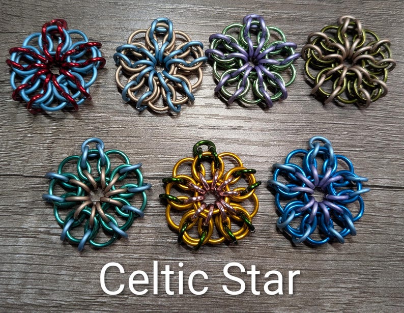 May include: Seven colorful Celtic Star pendants in various shades of blue, green, purple, gold, and silver. Each star-shaped pendant is crafted from interlocking metal rings. The text "Celtic Star" is displayed at the bottom.