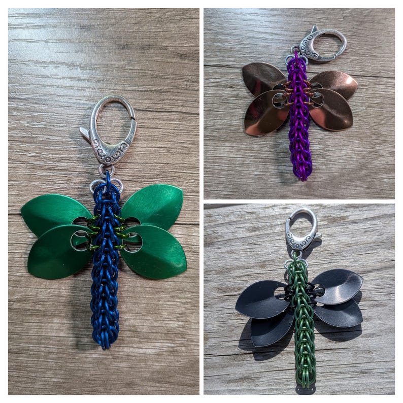 May include: Three dragonfly keychains. One has green wings and a blue body, another has copper wings and a purple body, and the third has black wings and a green body. Each keychain has a silver clasp.