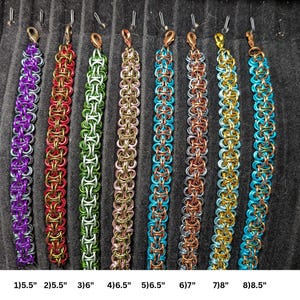 May include: Eight chainmaille bracelets in various colors including purple, red, green, pink, blue, copper, gold, and turquoise. Each bracelet features a lobster claw clasp and is labeled with lengths from 5.5 inches to 8.5 inches at the bottom.