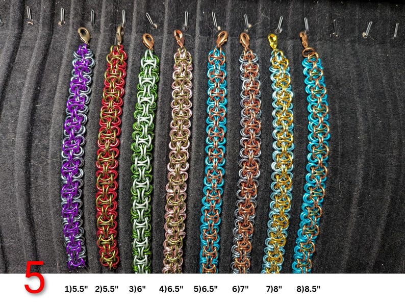 May include: Eight chainmaille bracelets in various colors including purple, red, green, pink, blue, copper, gold, and turquoise. Each bracelet features a lobster claw clasp and is labeled with lengths from 5.5 inches to 8.5 inches at the bottom.