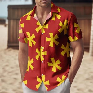 May include: Red button-down shirt with a yellow starburst pattern. The short-sleeved shirt has a classic collar and is made of a lightweight fabric. The shirt is worn by a person on a beach.
