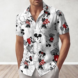 May include: White button-down shirt featuring a repeating pattern of Mickey and Minnie Mouse in various poses. The cartoon characters are in red, black, and white. The shirt has a classic collar and short sleeves.