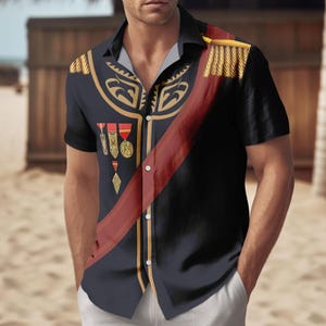 May include: Black button-down shirt with a military-style design. The shirt features gold epaulettes, decorative gold trim, and a red sash. It also has several medals and a diamond-shaped pendant. The shirt is worn with white pants.