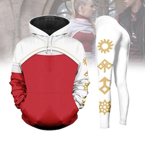 May include: A red and white hoodie with a black interior hood and gold accents. The hoodie is paired with white leggings featuring gold geometric designs. The clothing set is displayed on a white background.