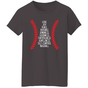 May include: Dark gray t-shirt featuring a baseball design with red stitching and the word "BASEBALL" at the bottom. The design includes a list of words: Love, Joy, Peace, Patience, Kindness, Goodness, Faithfulness, Gentleness, and Self-Control.