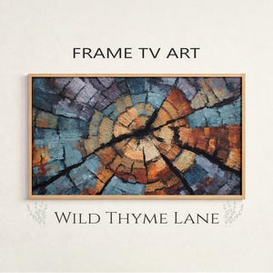 Könnte beinhalten: Rechteckiger gerahmter Kunstdruck mit einem Holzmaserungsdesign in Blau-, Orange- und Lilatönen. Der Text "FRAME TV ART" steht über dem Kunstwerk und "WILD THYME LANE" darunter.