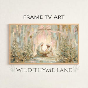 May include: A framed artwork depicting a Nativity scene with soft pastel colors. The image shows Mary and Joseph with baby Jesus in a manger, surrounded by evergreen trees. The text "FRAME TV ART" and "WILD THYME LANE" are visible.
