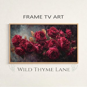 May include: A framed floral art print featuring a cluster of deep red roses. The artwork is set against a dark, moody background with the text "FRAME TV ART" and "WILD THYME LANE". The frame is a light brown color.
