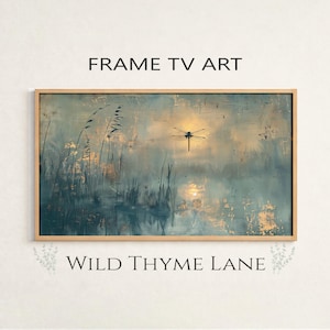 May include: Rectangular framed art print with a nature scene. The artwork features a dragonfly silhouette against a teal and gold background, with reeds and water in the foreground. The text "FRAME TV ART" and "WILD THYME LANE" are displayed.