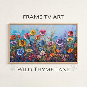 Peut inclure: Peinture florale encadrée avec un fond bleu clair. L'œuvre présente un éventail vibrant de fleurs colorées dans des tons de rouge, orange, jaune, violet et bleu. Le texte "FRAME TV ART" et "WILD THYME LANE" sont affichés.