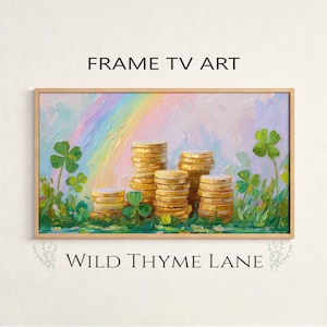 May include: Framed artwork with a St. Patrick's Day theme. The painting depicts stacks of gold coins, four-leaf clovers, and a rainbow against a pastel background. The text "FRAME TV ART" and "WILD THYME LANE" are visible.