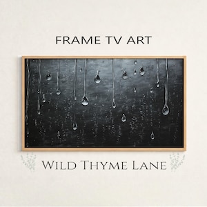May include: A framed art piece for a TV screen, featuring a dark background with realistic water droplets and streaks. The artwork is enclosed in a light brown wooden frame. The text "FRAME TV ART" and "WILD THYME LANE" are displayed.