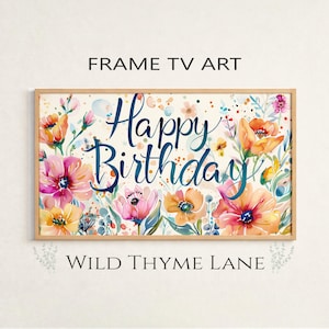 May include: A framed art print with a floral design and the words "Happy Birthday". The watercolour artwork features pink, orange, and yellow flowers. The text "FRAME TV ART" and "WILD THYME LANE" are also visible on the print.