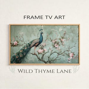 May include: Framed art print featuring a peacock perched on a flowering branch. The artwork has a teal and pink color palette with the text "FRAME TV ART" and "WILD THYME LANE". The frame is a light wood color.