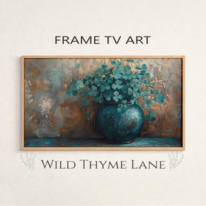 May include: A framed digital art print featuring a teal vase filled with green shamrocks against a textured background of teal and gold. The text "FRAME TV ART" and "WILD THYME LANE" are displayed on the image.