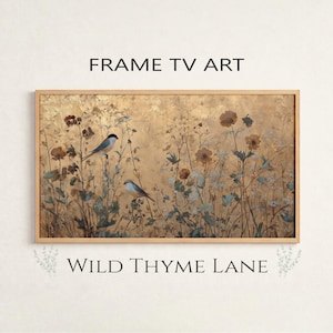 Könnte beinhalten: Gerahmter digitaler Kunstdruck mit goldenem Hintergrund, der zwei Vögel zwischen Wildblumen zeigt. Der Text "FRAME TV ART" steht oben und "WILD THYME LANE" unten.