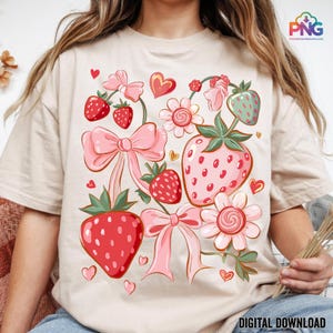 May include: Beige t-shirt featuring a strawberry-themed design. The graphic includes pink bows, strawberries, flowers, and hearts. The words "DIGITAL DOWNLOAD" are printed at the bottom right corner of the shirt.