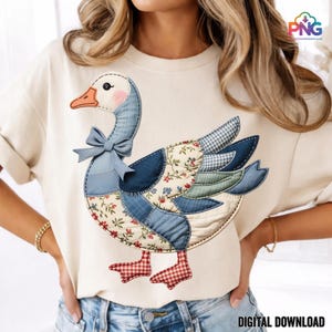 May include: A cream-coloured t-shirt with a patchwork goose design. The goose has a blue bow, a pink cheek, and a beak. The goose's body is made of various fabric patterns, including floral and gingham. The words "DIGITAL DOWNLOAD" are at the bottom.