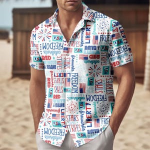 May include: White button-down shirt with a patriotic print featuring red, white, and blue text and graphics. The shirt's design includes the words "Freedom," "Liberty," "Stars," and "Stripes," along with American flags and fireworks.