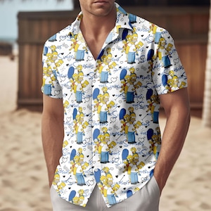 May include: White button-down shirt with a repeating pattern of The Simpsons characters, hearts, and the show's logo. The short-sleeved shirt features Homer, Marge, Bart, Lisa, and Maggie Simpson in various poses. The shirt is worn by a person.
