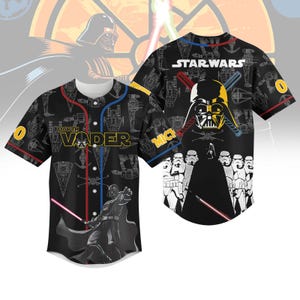 May include: Black baseball jersey featuring Star Wars graphics. The jersey has a white collar and buttons, with red and blue accents. The front displays "Darth Vader" and an image of Darth Vader. The back shows the Star Wars logo and Darth Vader's helmet.