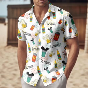 May include: White button-down shirt with a colorful pattern of beer mugs, bottles, and cans. The shirt has the text "I'M HERE FOR THE DRINKS" repeated throughout the design. The shirt is short-sleeved and has a relaxed fit.