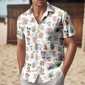 May include: White short-sleeved shirt with a vibrant all-over print of Disney characters and landmarks. The shirt features Mickey Mouse, Minnie Mouse, Donald Duck, and Chip and Dale. The shirt is worn by a person.