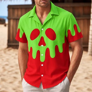 May include: A short-sleeve button-down shirt featuring a vibrant red and lime green color scheme. The design displays a lime green top section with a dripping liquid effect over a solid red base, incorporating a stylized skull graphic on the chest.