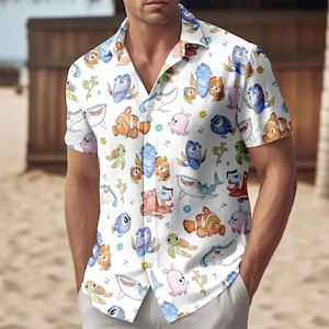 May include: White short-sleeve button-down shirt featuring a colorful cartoon fish pattern. The shirt has a classic collar and is made of a lightweight fabric. The design includes various fish characters, sea turtles, and other marine life.